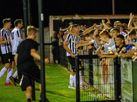 Elliot Sandy celebrates with the Corby Town fans after his 50th goal for the club secured a 1-0 win over Soham Town Rangers at Steel Park. Pictures by Jim Darrah