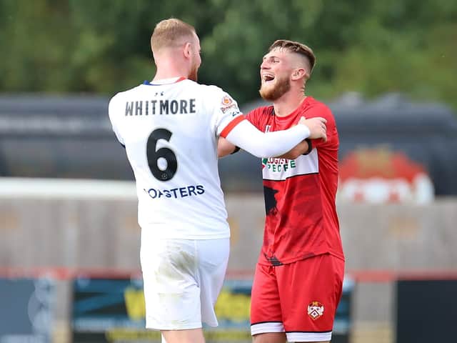 Kettering Town captain Connor Kennedy shares a joke with AFC Fylde skipper Alex Whitmore at the final whistle after the two team drew 1-1 at Latimer Park last weekend. Picture by Peter Short