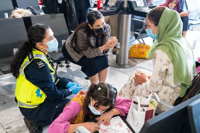 Home Secretary meets Afghan refugees at Heathrow Airport. Image: Getty.