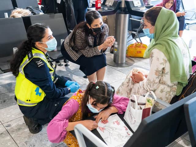Home Secretary meets Afghan refugees at Heathrow Airport. Image: Getty.