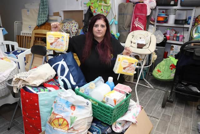Claire Gurney with items being donated to refugee families in Leicester