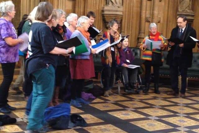 Singing in the Houses of Parliament lobby with her anti-nuclear campaign friends. Paula is in the rainbow jumper.