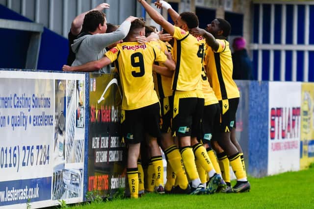 The AFC Rushden & Diamonds players celebrate Ben Diamond’s winner at Nuneaton last weekend. Picture courtesy of Hawkins Images