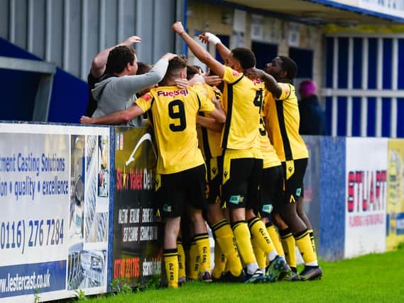 The AFC Rushden & Diamonds players celebrate Ben Diamond’s winner at Nuneaton last weekend. Picture courtesy of Hawkins Images