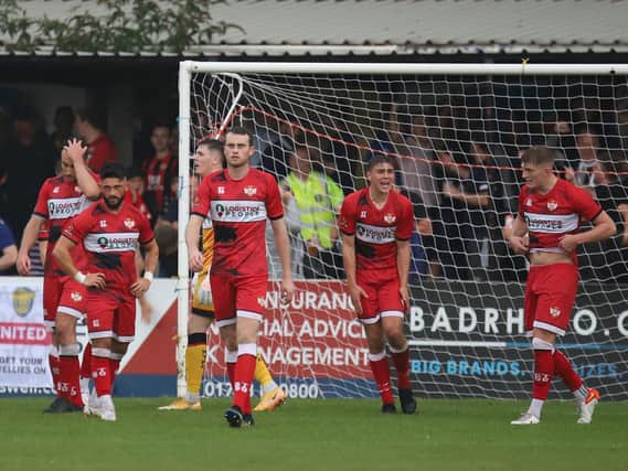 The look on the Kettering Town players' faces tells the story after the conceded a stoppage-time equaliser at Spalding United. Pictures by Peter Short