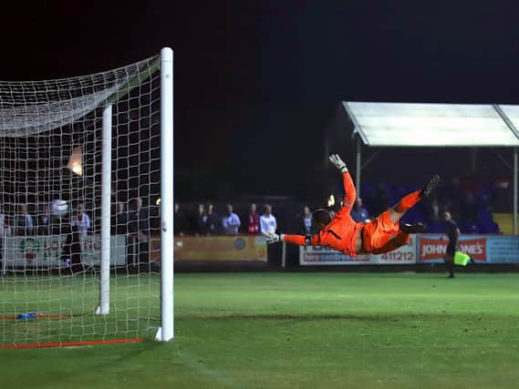 Claudio Ofosu's fine strike beats the despairing dive of Spalding United goalkeeper Michael Duggan to give Kettering Town the lead before they went on to seal a 2-0 win in the FA Cup second qualifying round replay at Latimer Park. Pictures by Peter Short