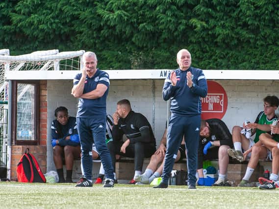 Corby Town manager Gary Mills and assistant Darron Gee watch on during the 3-0 win at Yaxley last weekend. Picture by Jim Darrah