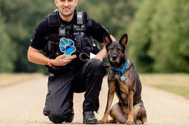 PC Sean Foster with Nala and her Thin Blue Paw lifetime achievement award