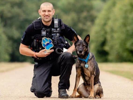 PC Sean Foster with Nala and her Thin Blue Paw lifetime achievement award