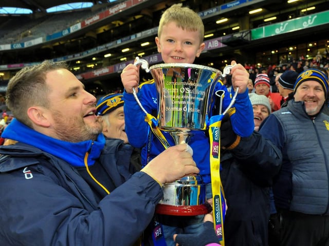 Steelstown manager Hugh McGrath and his nephew Hugh Hetherington (aged 8) with the AIB All Ireland Intermediate Club Football Championship trophy