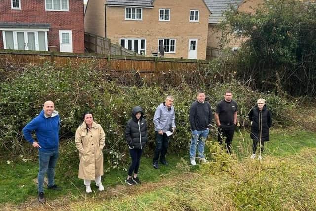 The residents next to what remains of the trees taken during Cllr Leanne Buckingham's visit to the site