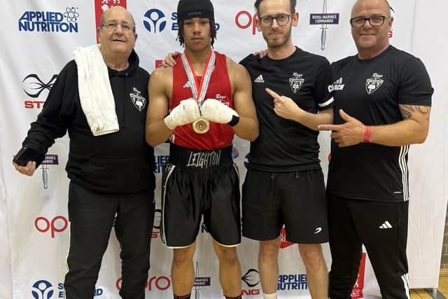 Leighton Forbes celebrates his success with the Wellingborough ABC backroom team