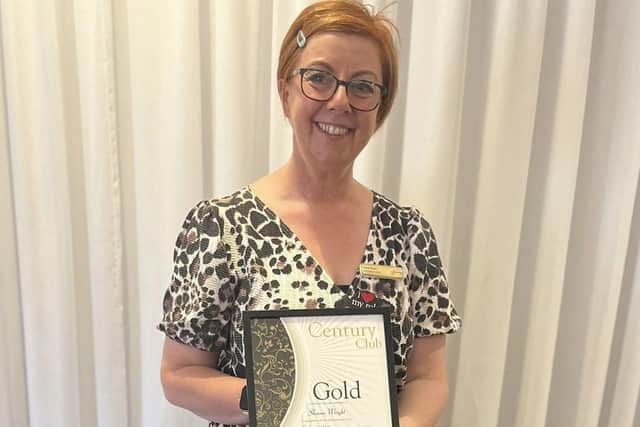 Sharon with her Gold Certificate.