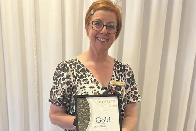 Sharon with her Gold Certificate.