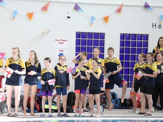 Swimmers watching the relay before the swim meet