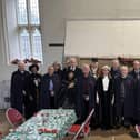 The  Bedesmen &amp; Bedeswoman ( in their cloaks)  line up with special guests in the Bede House 