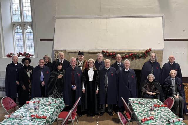 The  Bedesmen &amp; Bedeswoman ( in their cloaks)  line up with special guests in the Bede House 