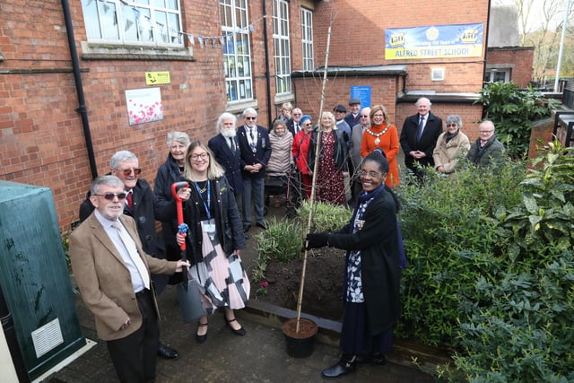 Morcea Walker plants a tree to mark the 150th anniversary with on left former headteachers John Kidney and Harry Curtis, and current headteacher Kelly O'Connor
