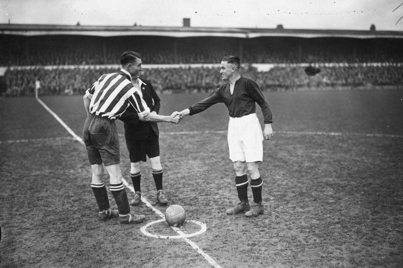 Southampton captain, Bradford, shakes hands with Northampton captain Tommy Crilly, before the kick off of an FA Cup tie replay between Northampton Town and Southampton at Northampton on 18th January 1934.