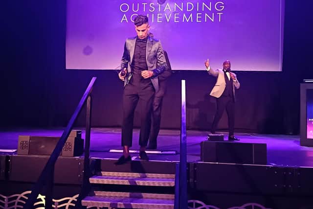 Dean collecting his award.