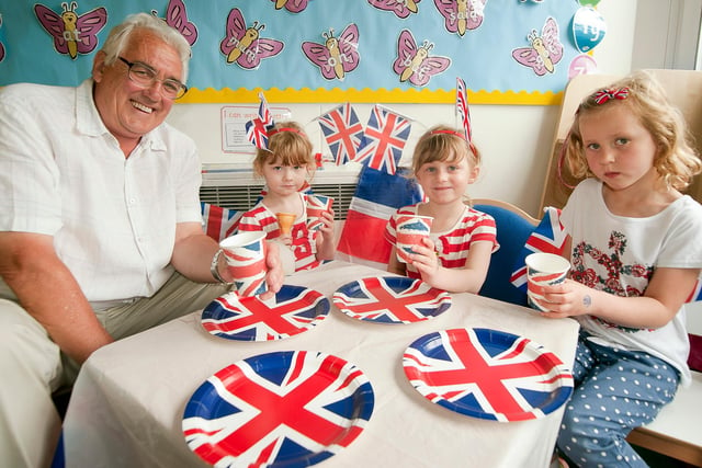 Queen's Diamond Jubilee celebrations at Dore Primary School, Sheffield on May 31, 2012. Granddad Lol Cutts with his two granddaughters,  Lottie and Sophia Belk, and Emiliy Bee
