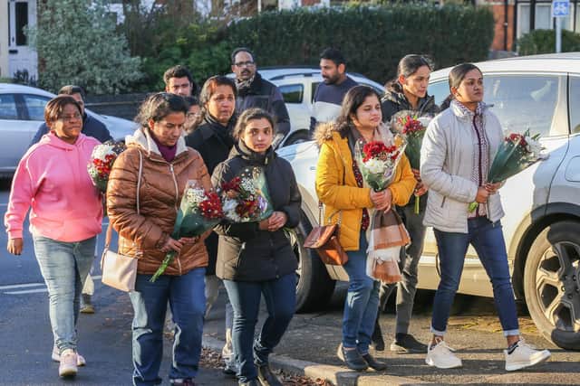 Staff from Kettering General Hospital where Anju Asok worked, arrive with flowers at the scene of the murders at Petherton Court, Kettering.  December 16, 2022.  Joseph Walshe / SWNS