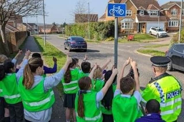 Children give a thumbs-up to drivers in Lake Avenue, Kettering