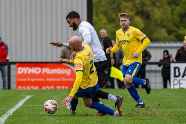 Corby Town striker Ryan Boothe is taken down (Picture: Jim Darrah)
