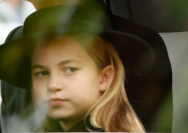 Princess Charlotte sits in a state car on her way to attend the state funeral and burial of Queen Elizabeth II at Westminster Abbey