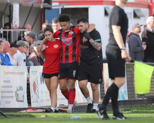 Blaine Rowe is helped off the pitch during the FA Cup defeat to Worcester City (Picture: Peter Short)