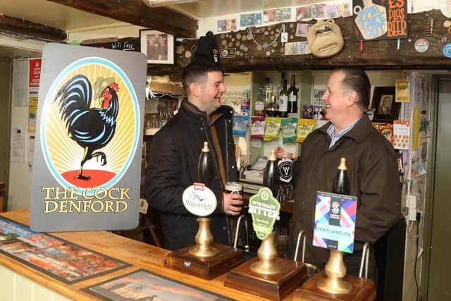 L-r owner Gareth Williams and Jayme Bent (landlord) behind the bar of the Cock Inn, Denford