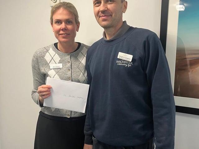 General Manager Elina House presents the £100 voucher to the home’s maintenance Assistant Serghei
