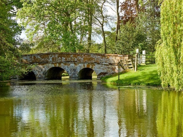 The home has traditional features as well as an indoor swimming pool, equestrian facilities and extensive parkland.