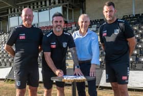 Leon Mettam (second from left) puts pen to paper on his Corby Town contract, flanked by (from left) Paul Holden, chairman Chris Mallender and Dabby Brooks (Picture: Jim Darrah)