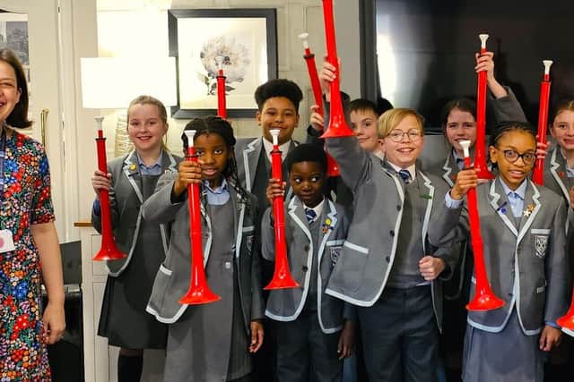 Teacher with the pupils from St Peter's School with the pBuzz instrument that delighted the residents of Elm Bank Care Home
