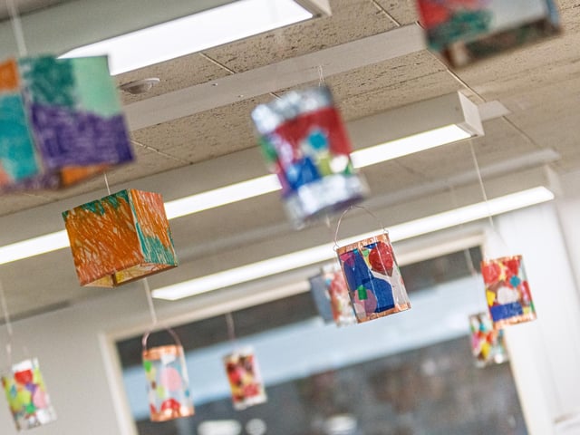 Lanterns crafted by Creative Support members, in sessions led by artist Phiona Richards hung from the ceiling at Wellingborough Library