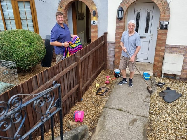 Nick Lattanzi and Richard Lund clear up after the flooding in Silverwood Road, Kettering