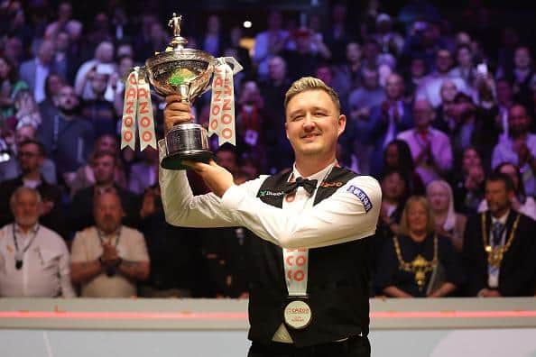 The world champion... Kettering's Kyren Wilson poses with the Cazoo World Snooker Championship trophy
