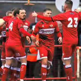 The Kettering Town players celebrate Connor Kennedy's opening goal in the 2-0 win over York City. Picture by Peter Short