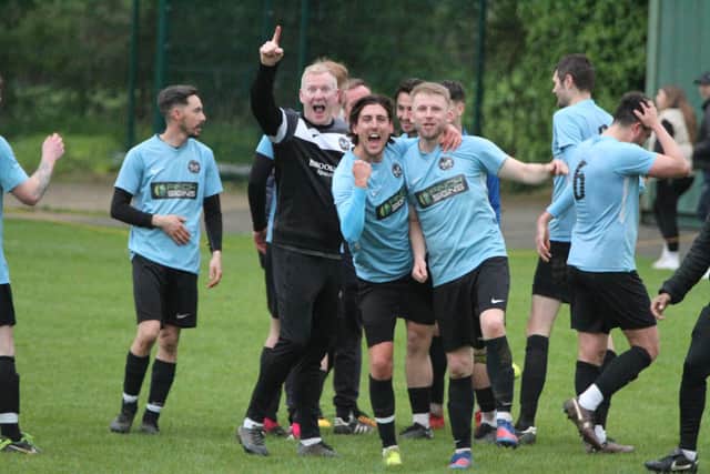 Manager Joe Rich and his players savour the moment after they sealed the Premier Division title