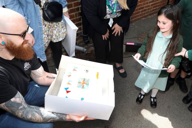 Butterwick's owner Ryan Scarborough shows Alice her winning design made into a cake