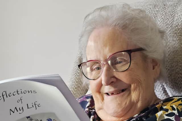 Jenny with a copy of her life story