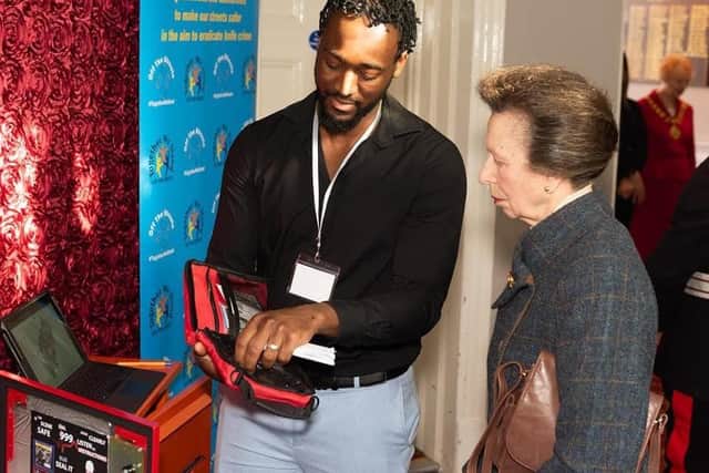 Anti-knife crime campaigner and founder of Off the Streets NN Ravaun Jones shows a critical bleed kit to The Princess Royal at a reception at the Hind Hotel in Wellingborough last month