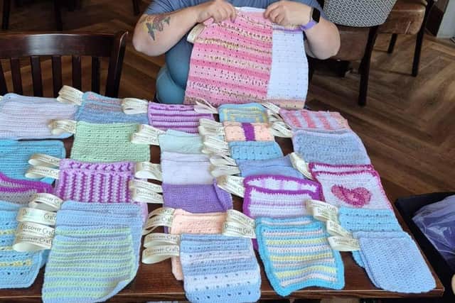 Tammy with just some of the bonding squares the group made for Kettering SCBU