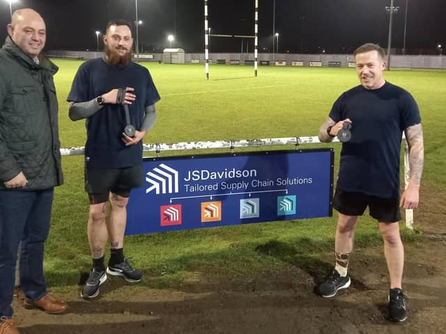 Nathan Hand and Alden Marshall from S&L Rugby Club presented with medals from the S&L Rugby Club president and the managing director of JS Davidson Ltd who sponsored the pair £1 each per kilometre.
