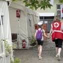 A Red Cross worker accompanies a child at the Red Cross Health Centre in Uzhhorod, eastern Ukraine