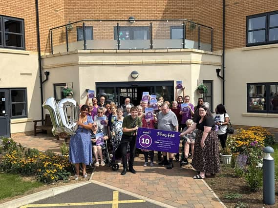 Residents and colleagues at Priors Hall celebrate the achievement