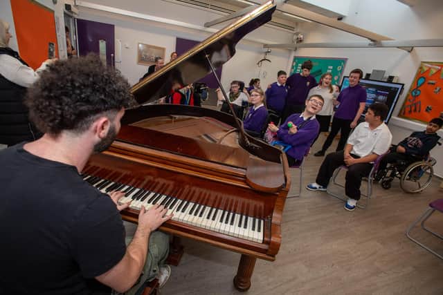 Billy Lockett visiting Greenfields Specialist School For Communication to donate the piano he wrote his debut album on. Photo by David Jackson.