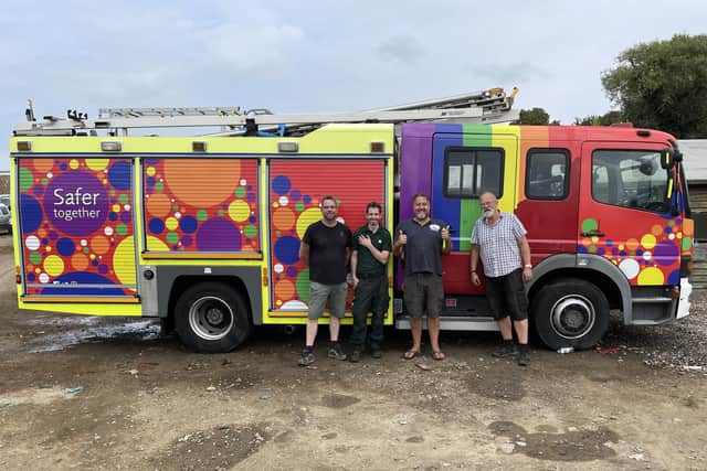 From left to right Phil Smith (Combat Cellar), Conor Braithwaite, Robert Frankham, and John Barrow standing in front of the fire engine prior to the removal of its stickers