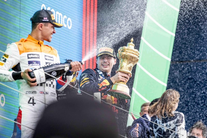 Winner Max Verstappen (centre) celebrates alongside second-placed Lando Norris